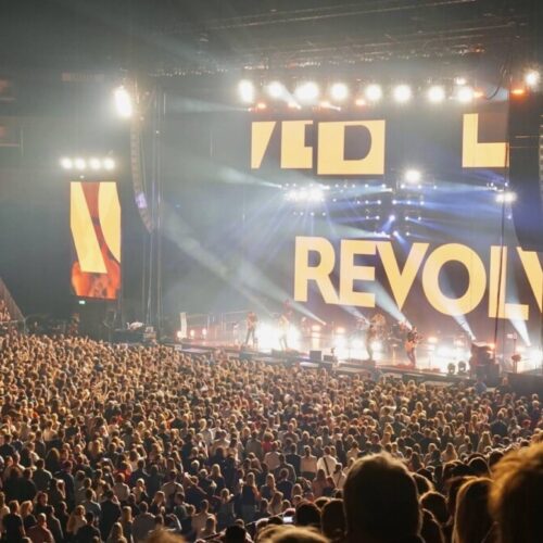 Huge crowd in front of a bright lit stage at a Revolverheld Concert produced by 1314