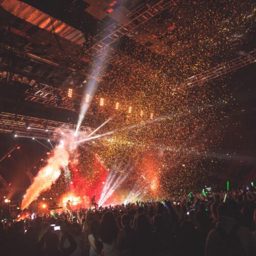 Huge crowd in front of a bright lit stage at a Tokio Hotel concert produced by 1314