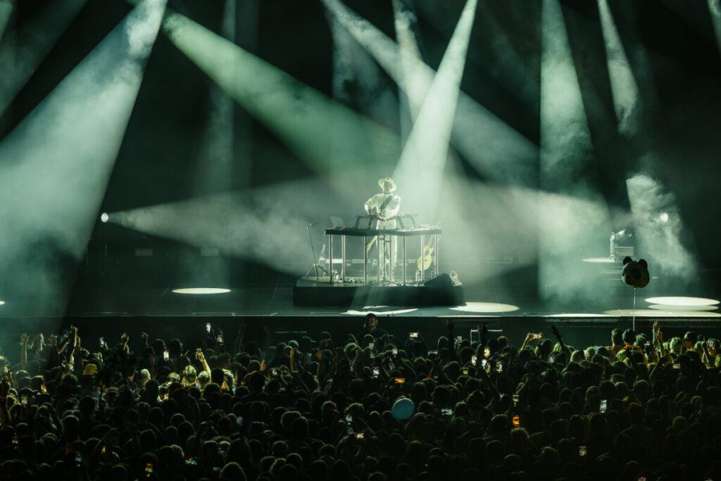 Huge crowd in front of a lit stage at a Monolink concert