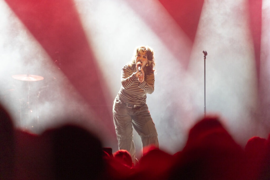 Lola Young on a lit stage in Germany