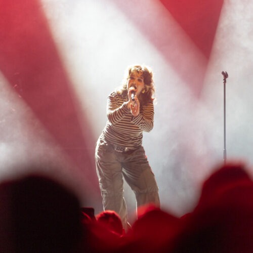 Lola Young on a lit stage in Germany