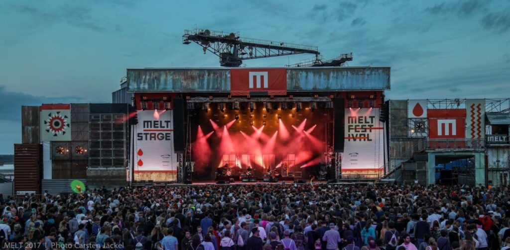Crowd in front of red lit MainStage of the Melt festival produced by 1314