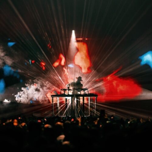 Huge crowd in front of a lit stage at a Monolink concert