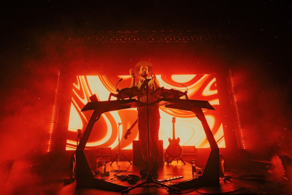 Monolink on stage with a red lit background